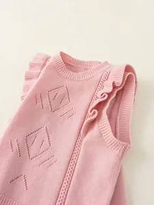 Pink knit sweater vest for girls with ruffle shoulders and hollow diamond patterns