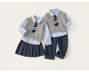 Detail of British school style uniforms featuring striped shirts and knit vests