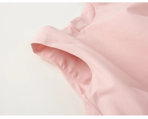 Vue détaillée du tissu en coton rose avec coutures fines sur un ensemble robe à volants