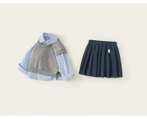 Flat lay of girl's school style outfit with striped shirt vest and pleated navy skirt