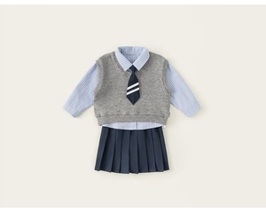 Detailed flat lay of girls' school uniform set with striped shirt and pleated skirt