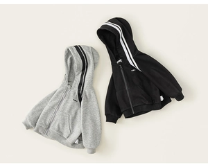 Detail view of boys zip-up hoodies in grey and black with ribbed cuffs and hooded design