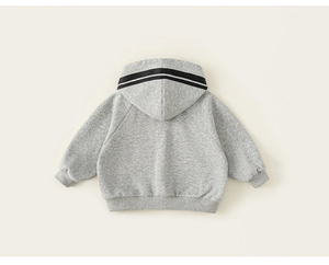 Macro shot of grey kids hoodie detail with ribbed cuffs and sporty black hood stripes