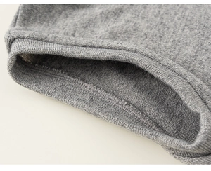 Macro detail of high-quality grey ribbed knit fabric and reinforced stitched cuffs