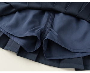 Detailed view of dark blue pleated skirt featuring integrated anti-exposure inner lining