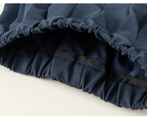 Detail of the elastic waistband on navy pleated skirt with professional stitching