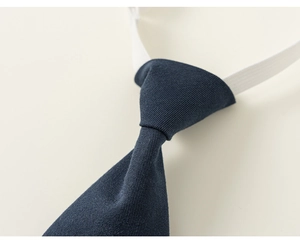 Close-up of navy blue twill fabric texture on a children's elastic school uniform tie