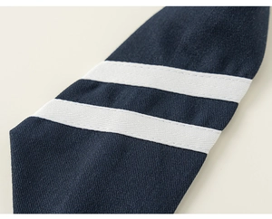 Detailed macro view showing navy blue twill fabric with double white stripe trim accent