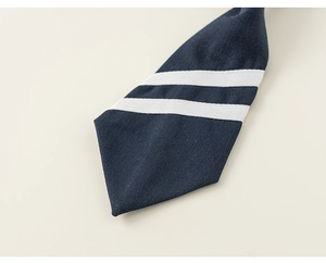 Detailed close-up of navy blue preppy style tie with white stripes on twill fabric