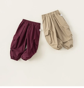 Close-up of children cargo pants in khaki and burgundy with elastic waist and side pockets