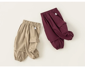 Detail of khaki and burgundy kids cargo pants with elastic waist and side pockets