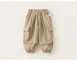 Detail of kids khaki cargo pants featuring elastic waistband and large flap side pockets