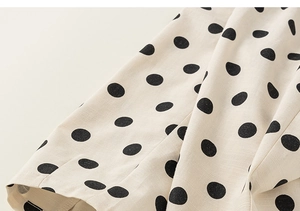 Detailed macro view showing the polka dot pattern and premium cotton fabric texture