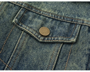 Detail of vintage copper button and orange contrast stitching on navy denim jacket