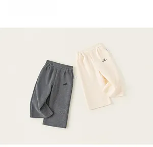 Flat lay of gray and cream toddler casual sweatpants with elastic waist and logo detail