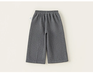 Detail view of dark gray kids wide-leg pants with elastic waistband and vertical pleats