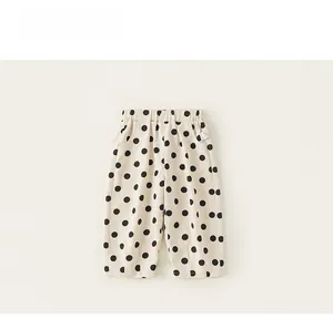 Detailed view of kids polka dot pants with elastic waistband and soft cotton linen fabric