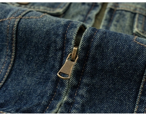 Close-up of girls denim jacket showing vintage metal zipper and washed fabric texture