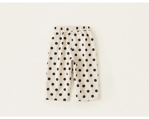 Detail shot of toddler girl's polka dot cotton trousers with elastic waistband