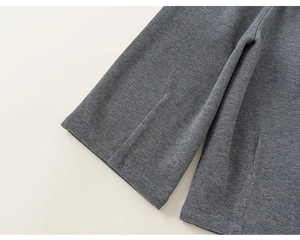 Detail view of smooth knitted cuff on dark grey casual pants for girls