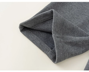 Close-up of fine grey knitted fabric detail showing high quality sewing on casual pants