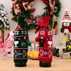 Christmas knitted wine bottle covers with snowflakes and pom-poms for festive decor