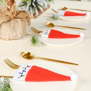 Christmas silverware holders shaped like Santa hats with colorful embroidery for table decor
