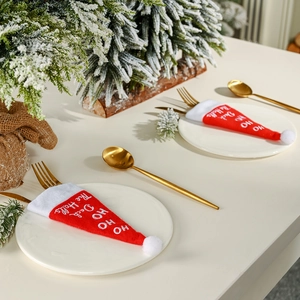 Mini red velvet Christmas hat cutlery holders featuring Ho Ho Ho festive embroidery