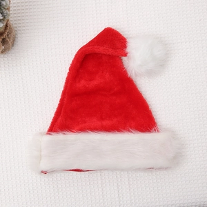 Flat lay of a plush red Christmas hat with white faux fur trim on waffle fabric