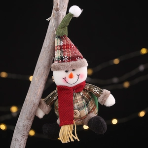 Christmas snowman plush ornament with red plaid hat and scarf on dark bokeh background
