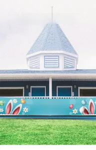 Outdoor fence display of a light blue Easter banner with bunnies and eggs