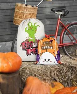 Detail of Halloween drawstring treat bags with pumpkin and ghost prints on straw