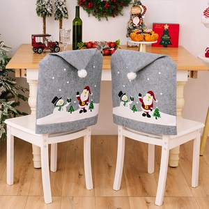 Close-up of grey Christmas chair covers with festive Santa and snowman cartoon prints