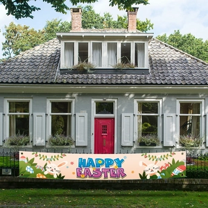 Happy Easter banner with bunny and eggs on a fence in front of a house entrance