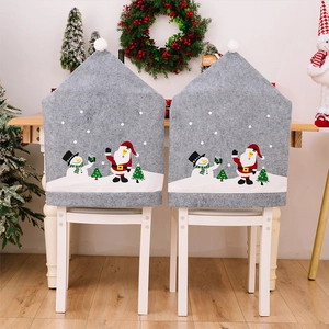 Detail of grey Christmas chair covers with snowman and santa claus plush ball decor