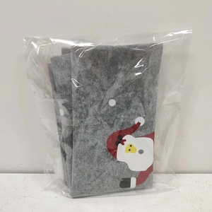 Close-up of Christmas grey felt chair cover with red hat print in protective plastic bag