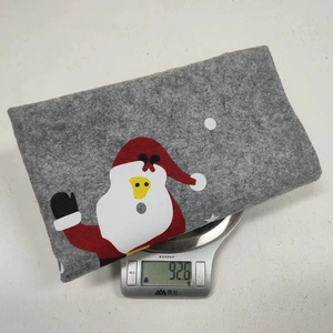 Detail showing the 92.6g weight of a Santa Claus printed grey felt chair cover