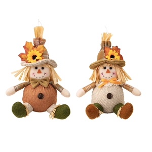 Pair of Thanksgiving harvest scarecrow dolls with maple leaves and sunflowers on hats