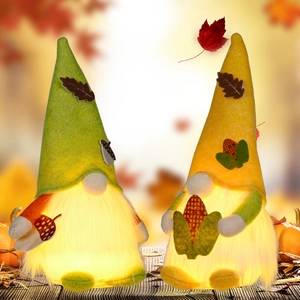 Lighted harvest gnomes with acorn and corn details on warm glowing bellies