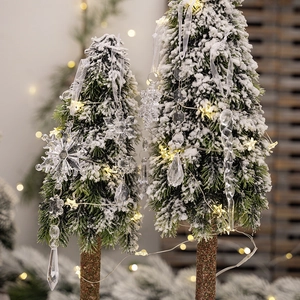 5pcs clear acrylic Christmas snowflake and icicle ornaments hanging on a lighted tree