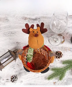 Détail du panier à bonbons renne en peluche sur neige avec des pommes de pin festives