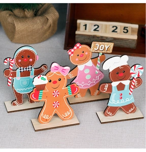 Detail view of four wooden Christmas gingerbread man ornaments with festive JOY signage