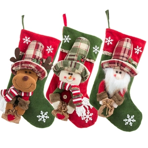 Three Christmas stockings with Reindeer, Snowman and Santa Claus cartoon designs