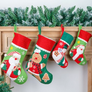 Set of four embroidered Christmas stockings with Santa and Gingerbread Man 3D designs