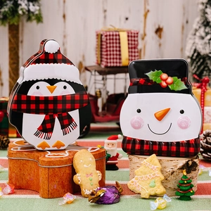 Christmas penguin and snowman tin boxes with red black plaid festive candy packaging