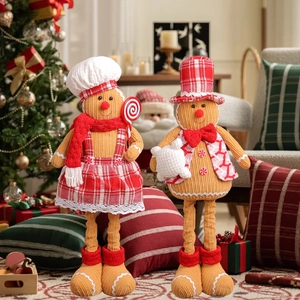 Pair of telescopic gingerbread man dolls with chef hats and red plaid festive outfits