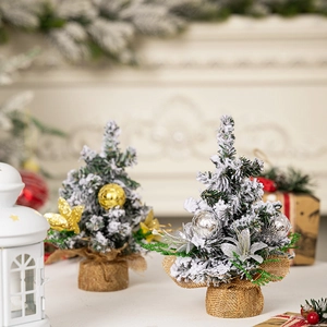 Miniature Christmas trees with artificial snow and burlap base for festive tabletop decor