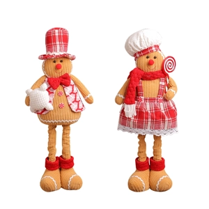 Pair of plush Christmas gingerbread chef dolls with telescopic legs on white background