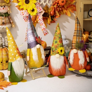 Set of four autumn fall gnomes with sunflowers and maple leaves for harvest decoration