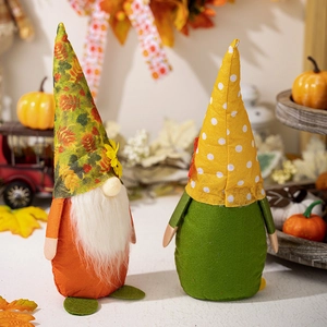 Charming pair of Thanksgiving autumn gnomes with fall leaf patterns and pumpkin decor